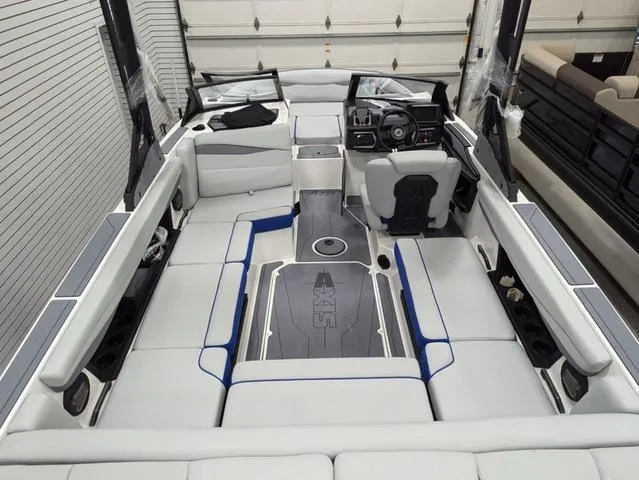 Slide: The Image of 2025 Axis A225 boat interior with sleek seating and modern dashboard. - 13