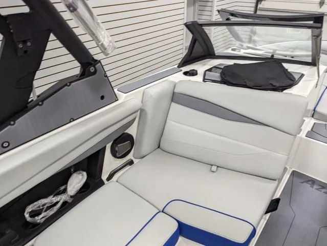 Slide: The Image of 2025 Axis A225 boat interior with sleek white and gray seating. - 16