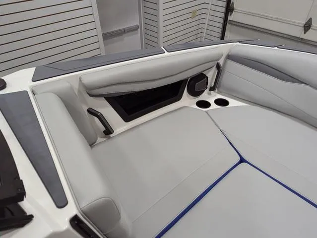 Slide: The Image of 2025 Axis A225 boat interior with gray seating and cup holders. - 7