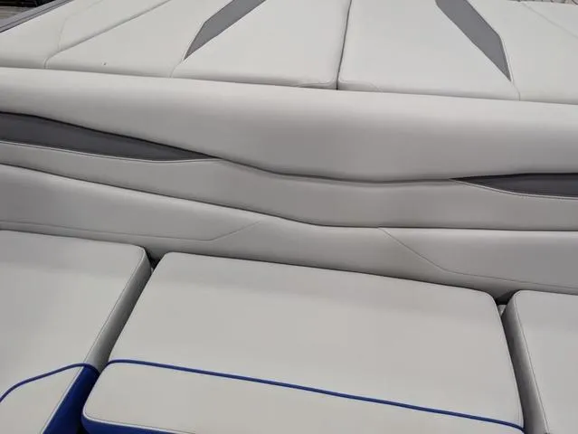 Slide: The Image of 2025 Axis A225 boat interior with sleek white and gray upholstery. - 8