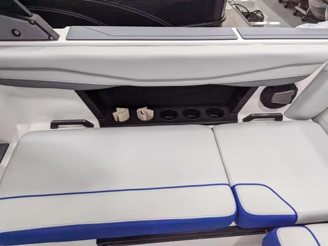 Slide: The Image of 2025 Axis A225 boat interior with white and blue seating, cup holders, and sleek design. - 9