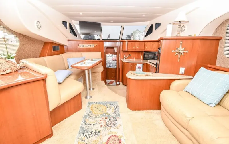 Slide: The Image of Luxurious 2007 Silverton 35 Motor Yacht interior with cozy seating and elegant wood finishes. - 11