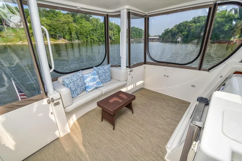 Slide: The Image of 2007 Silverton 35 Motor Yacht interior with scenic lake view and comfortable seating. - 18