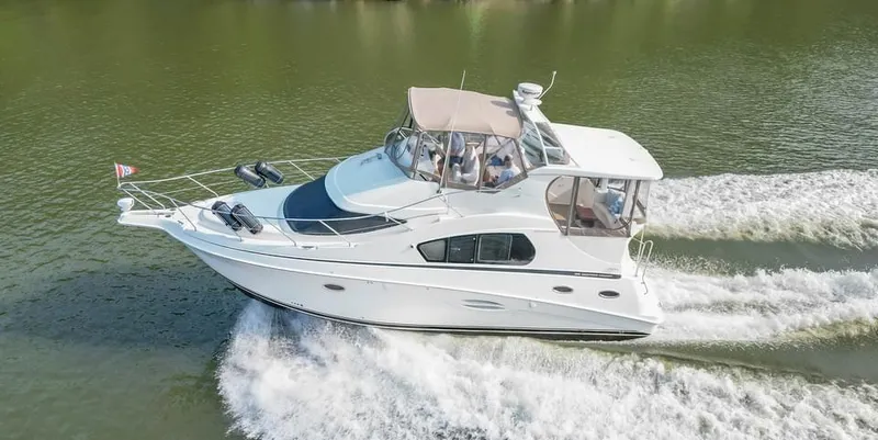 Slide: The Image of 2007 Silverton 35 Motor Yacht cruising on a calm river. - 2
