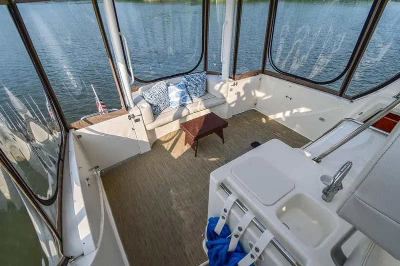 Slide: The Image of 2007 Silverton 35 Motor Yacht interior with seating and table, overlooking water. - 21