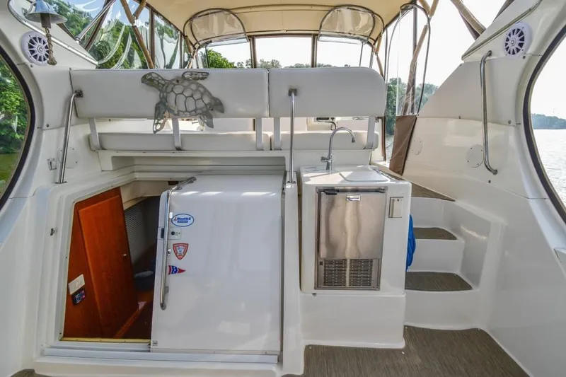 Slide: The Image of 2007 Silverton 35 Motor Yacht interior with kitchenette and stairs, featuring turtle decor. - 22