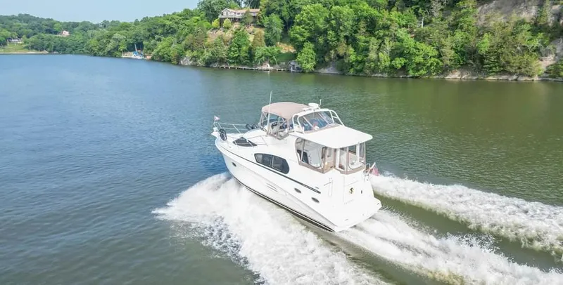Slide: The Image of 2007 Silverton 35 Motor Yacht cruising on a scenic river. - 26