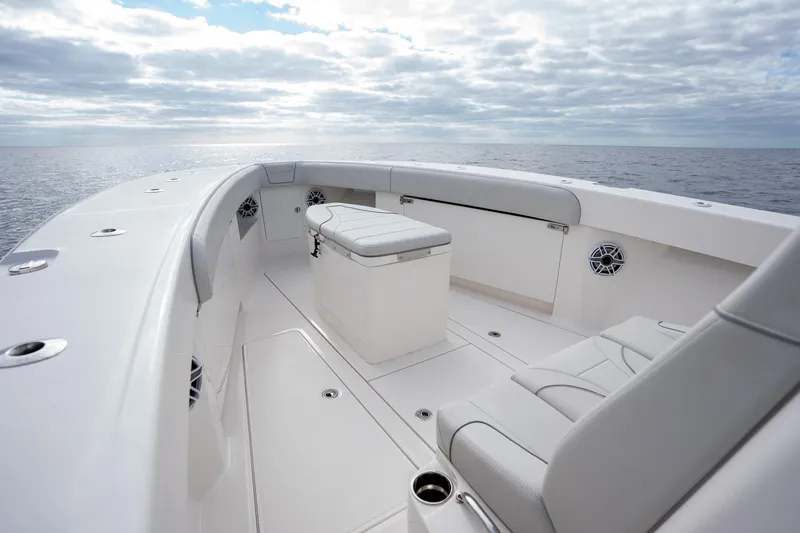 Slide: The Image of 2022 SeaVee 370z boat interior with seating, ocean view, and cloudy sky. - 13