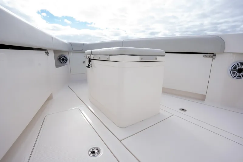 Slide: The Image of 2022 SeaVee 370z boat deck with storage compartment and speakers under cloudy sky. - 14