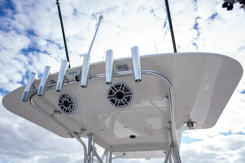 Slide: The Image of 2022 SeaVee 370z boat with rod holders and speakers against a cloudy sky. - 27