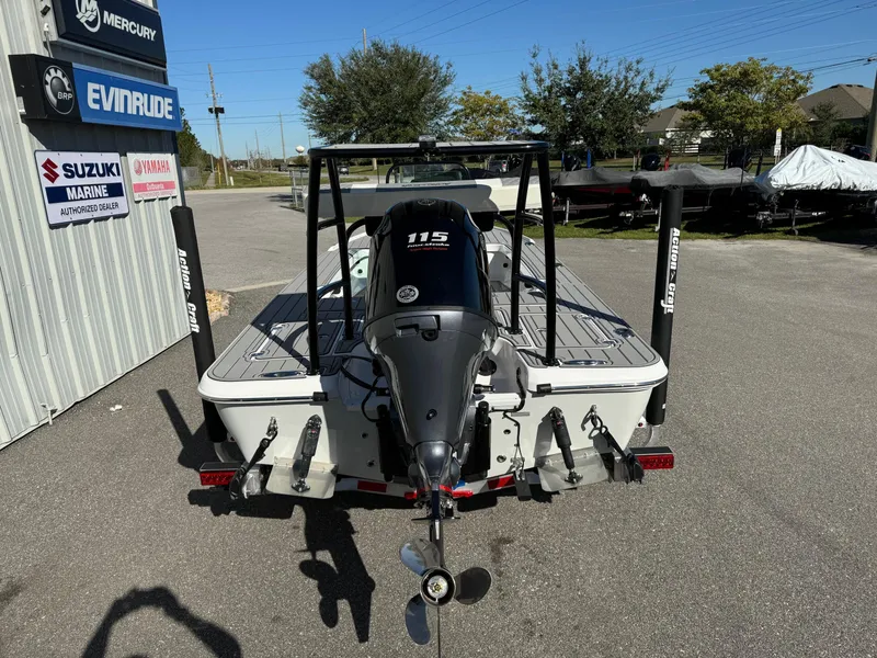 Slide: The Image of 2025 Action Craft 17 FLYFISHER boat with 115 HP engine, parked outdoors. - 13