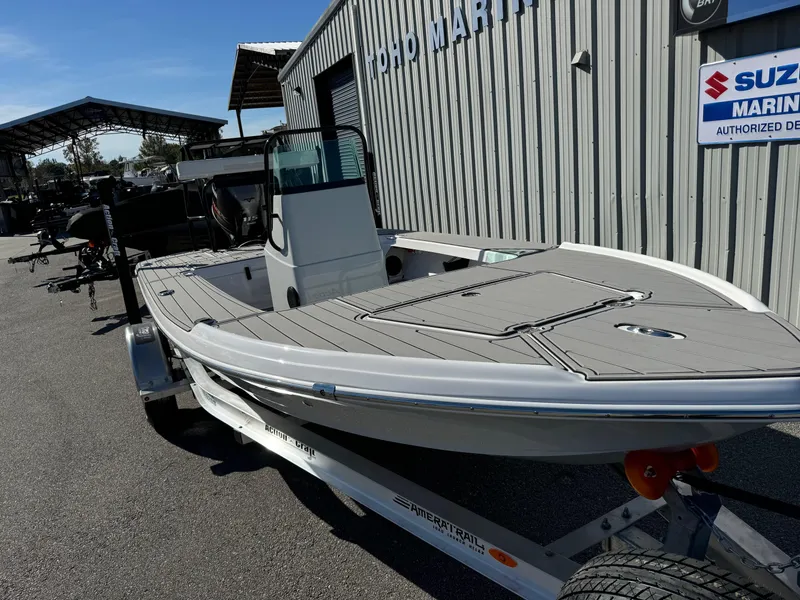 Slide: The Image of 2025 Action Craft 17 Flyfisher boat on trailer at marina. - 2