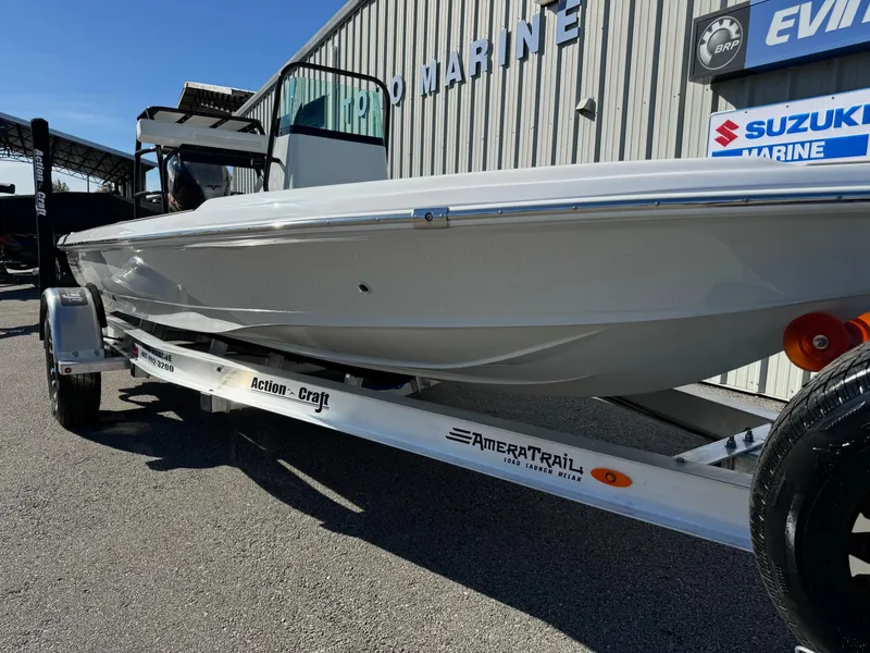 Slide: The Image of 2025 Action Craft 17 Flyfisher boat on trailer, parked outside marine dealership. - 5
