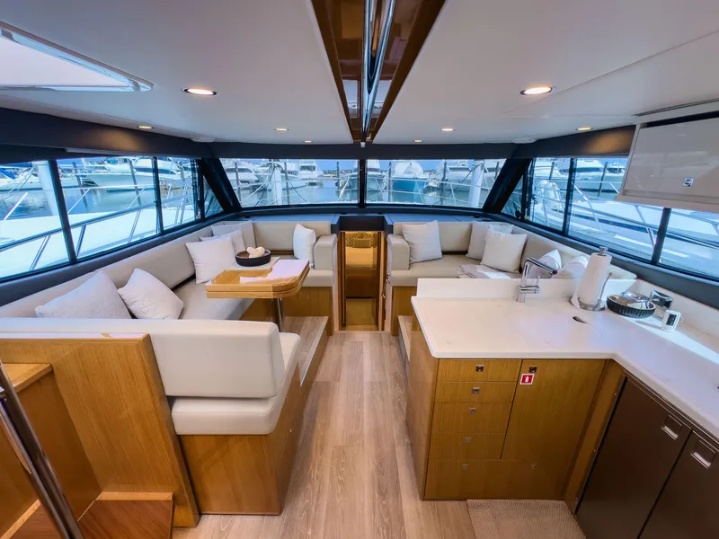 Slide: The Image of Luxurious interior of 2024 Riviera SMY 46 yacht with modern seating and panoramic windows. - 13