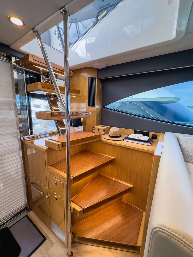 Slide: The Image of 2024 Riviera SMY 46 yacht interior with wooden stairs and modern design elements. - 14