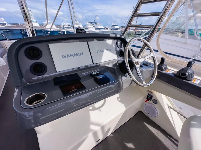 Slide: The Image of 2024 Riviera SMY 46 helm with Garmin displays and modern steering wheel. - 17