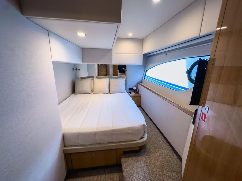 Slide: The Image of 2024 Riviera SMY 46 yacht cabin with modern interior and large window. - 19