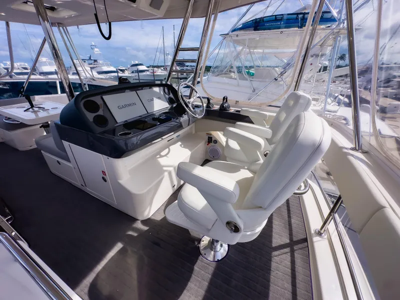 Slide: The Image of Luxurious 2024 Riviera SMY 46 yacht helm with modern controls and plush seating. - 2