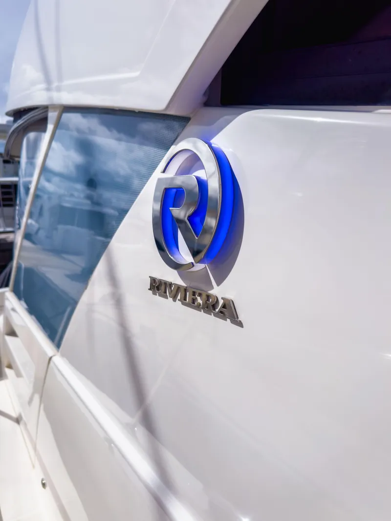 Slide: The Image of 2024 Riviera SMY 46 yacht with sleek design and logo detail. - 8
