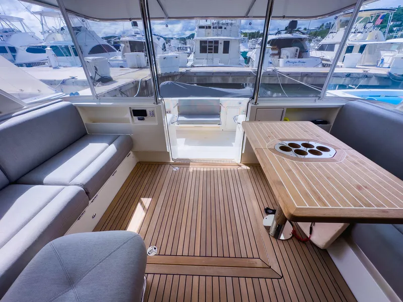 Slide: The Image of Luxurious 2024 Riviera SMY 46 yacht interior with elegant seating and wooden table. - 9