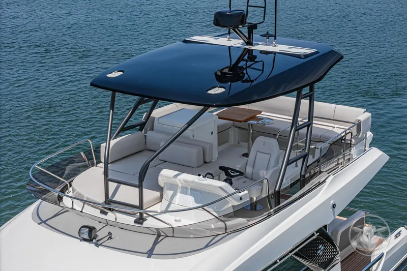 Slide: The Image of Luxury Prestige F4.9 yacht, 2025 model, with sleek design and spacious deck on the water. - 10