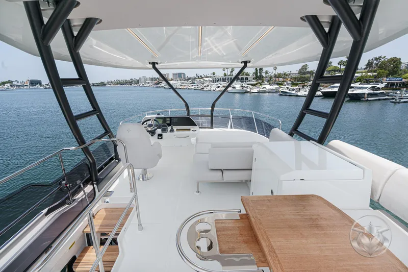 Slide: The Image of Luxurious 2025 Prestige F4.9 yacht interior with elegant seating and scenic marina view. - 14