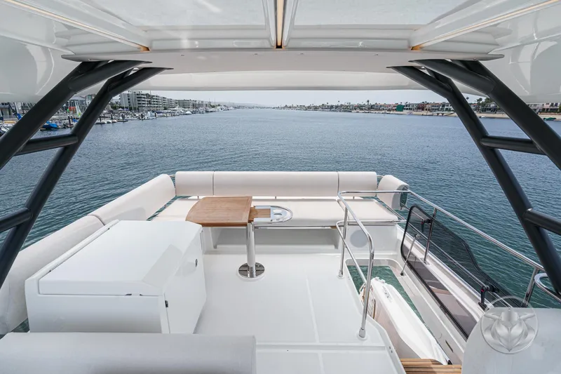Slide: The Image of Luxurious 2025 Prestige F4.9 yacht deck with seating, table, and ocean view. - 17