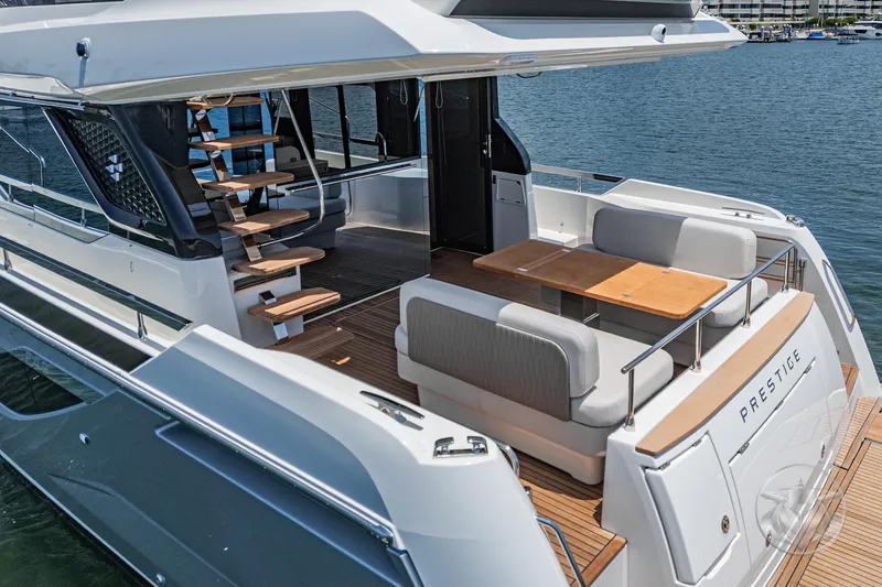 Slide: The Image of 2025 Prestige F4.9 yacht with elegant deck seating and modern design on the water. - 19