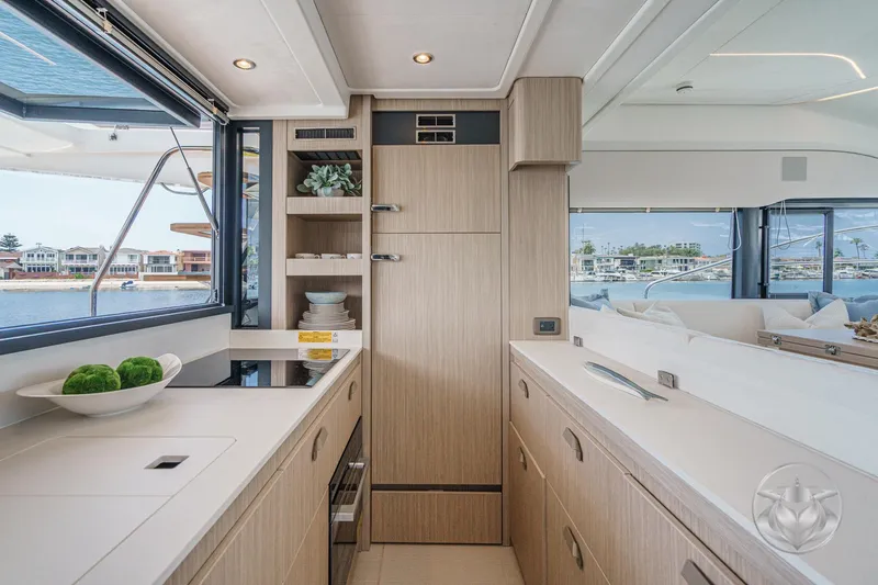 Slide: The Image of Modern yacht kitchen interior with sleek cabinetry, large windows, and waterfront view. Prestige F4.9, 2025 model. - 27
