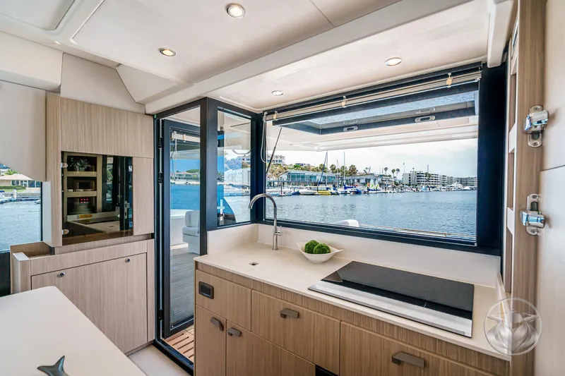 Slide: The Image of Modern yacht kitchen interior with waterfront view, featuring sleek cabinetry and appliances. Prestige F4.9, 2025 model. - 29