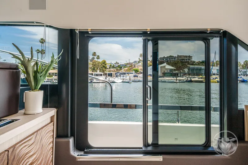 Slide: The Image of Interior view of Prestige F4.9 yacht, showcasing marina through sliding glass door, 2025 model. - 31