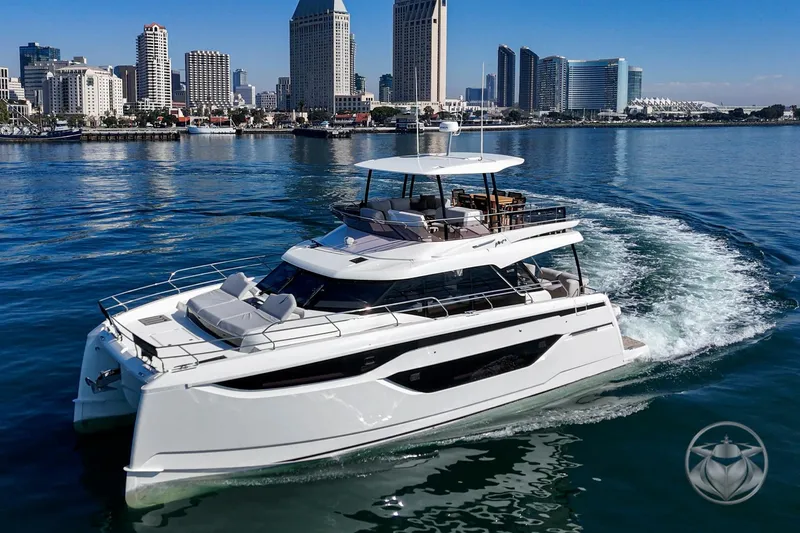Slide: The Image of Luxurious 2026 Prestige M48 yacht cruising near a city skyline on a sunny day. - 16