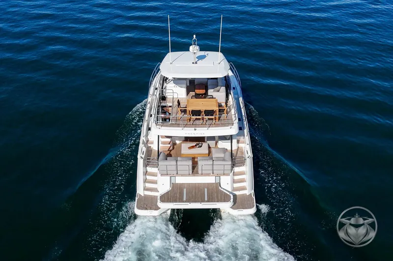 Slide: The Image of 2026 Prestige M48 yacht cruising on open water, aerial view. - 19