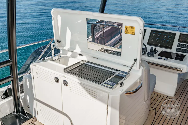 Slide: The Image of Luxury yacht Prestige M48 2026 with outdoor grill and control panel. - 24