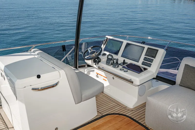 Slide: The Image of Helm of 2026 Prestige M48 yacht with modern navigation equipment and ocean view. - 26