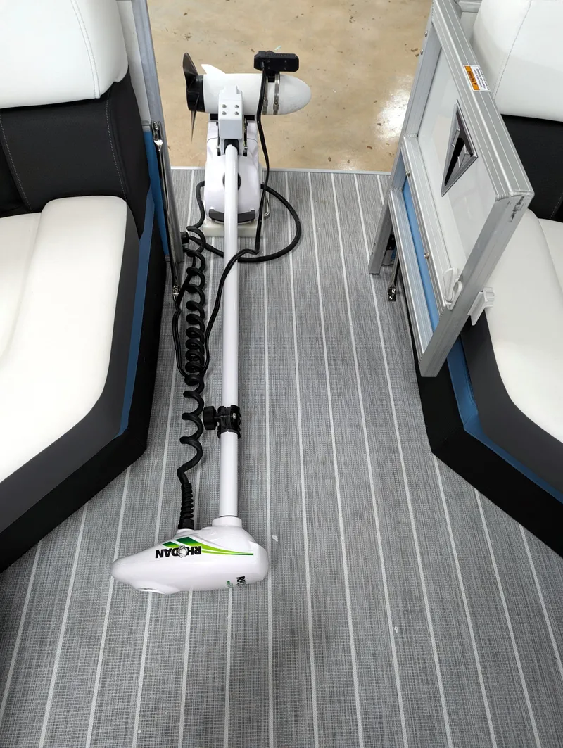 Slide: The Image of 2025 Trifecta CS 22RFC boat interior with trolling motor on striped flooring. - 12