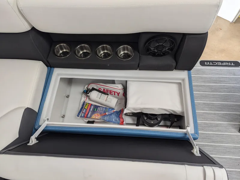 Slide: The Image of 2025 Trifecta CS 22RFC boat seat storage with safety gear and cup holders. - 19