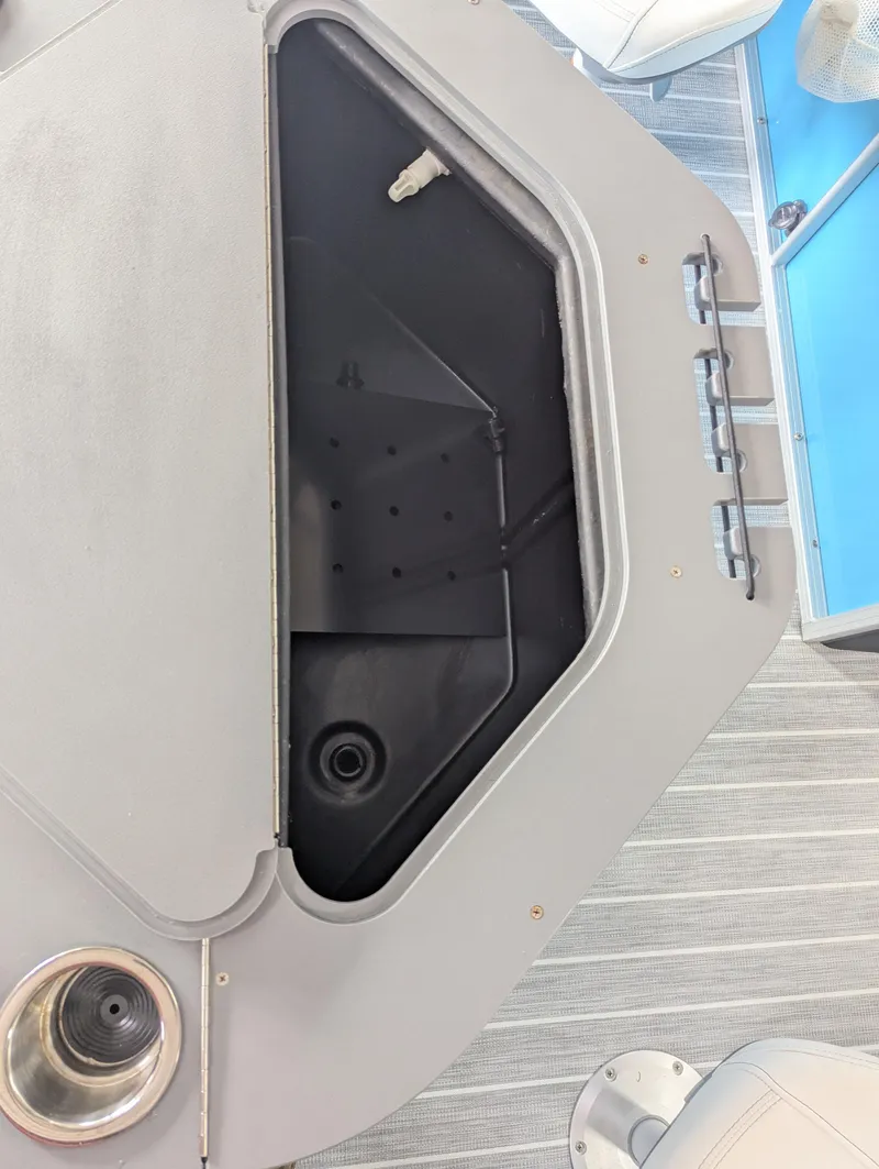 Slide: The Image of 2025 Trifecta CS 22RFC boat storage compartment with cup holder and seating area. - 24