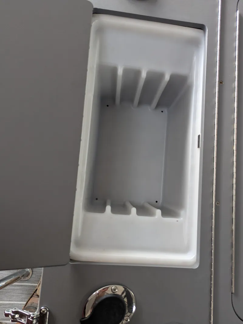 Slide: The Image of Open storage compartment in 2025 Trifecta CS 22RFC boat. - 25