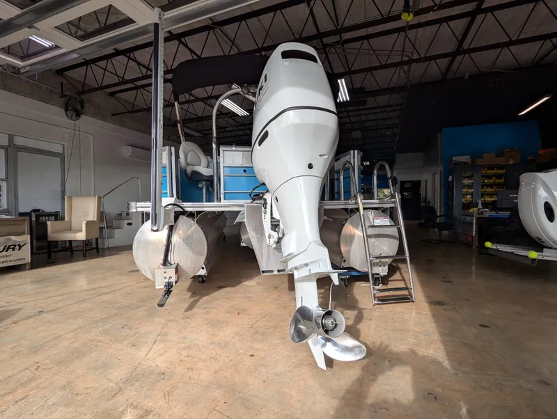 Slide: The Image of 2025 Trifecta CS 22RFC boat in a workshop, showcasing its powerful outboard motor. - 26