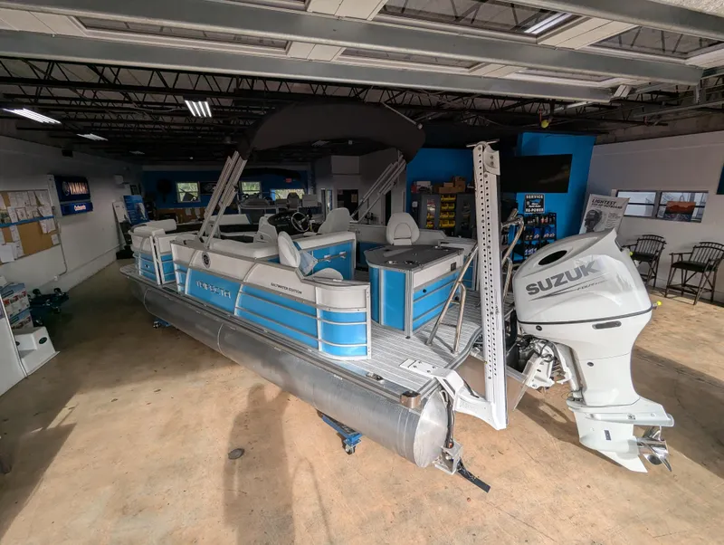 Slide: The Image of 2025 Trifecta CS 22RFC pontoon boat with Suzuki outboard motor in showroom. - 3