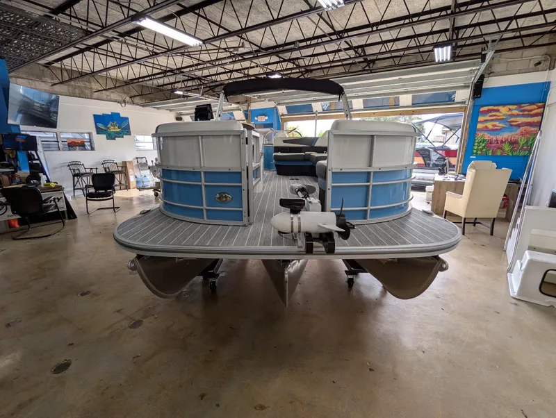 Slide: The Image of 2025 Trifecta CS 22RFC pontoon boat in showroom, rear view. - 4