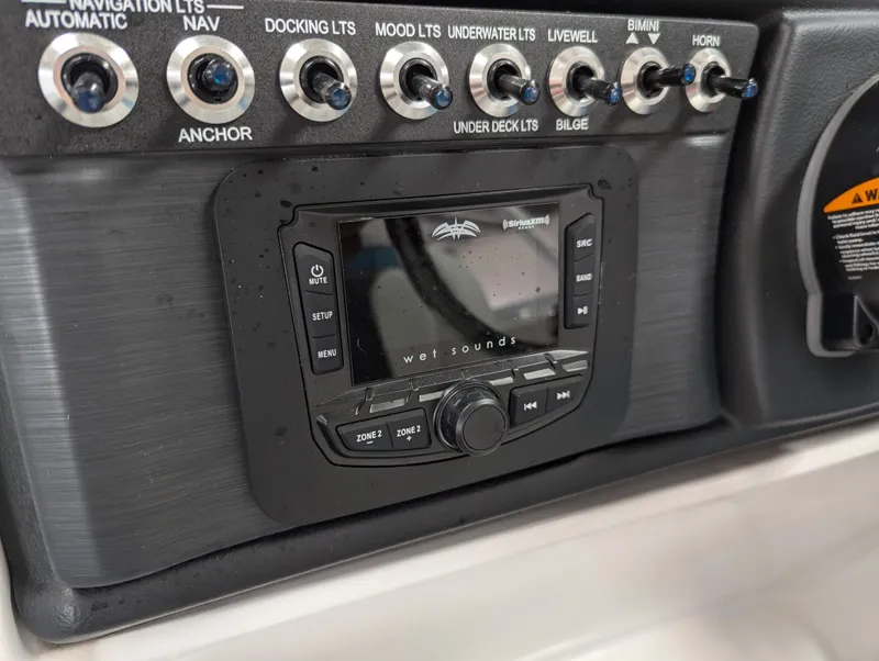 Slide: The Image of Control panel of 2025 Trifecta CS 22RFC boat with switches and audio system. - 9