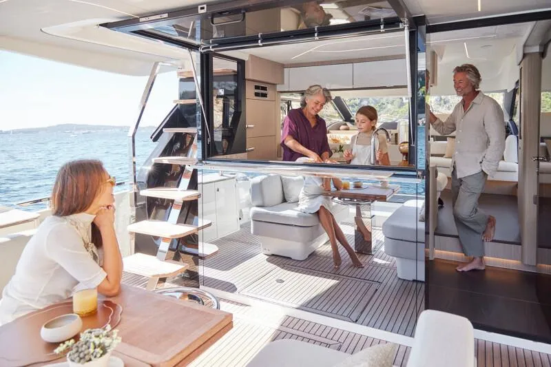 Slide: The Image of Prestige F5.7 yacht, 2026 model, cruising on calm waters, front view. - 12