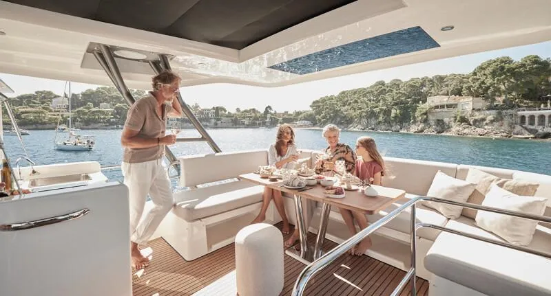 Slide: The Image of Luxury 2026 Prestige F5.7 yacht cruising on calm waters, showcasing sleek design and modern features. - 13