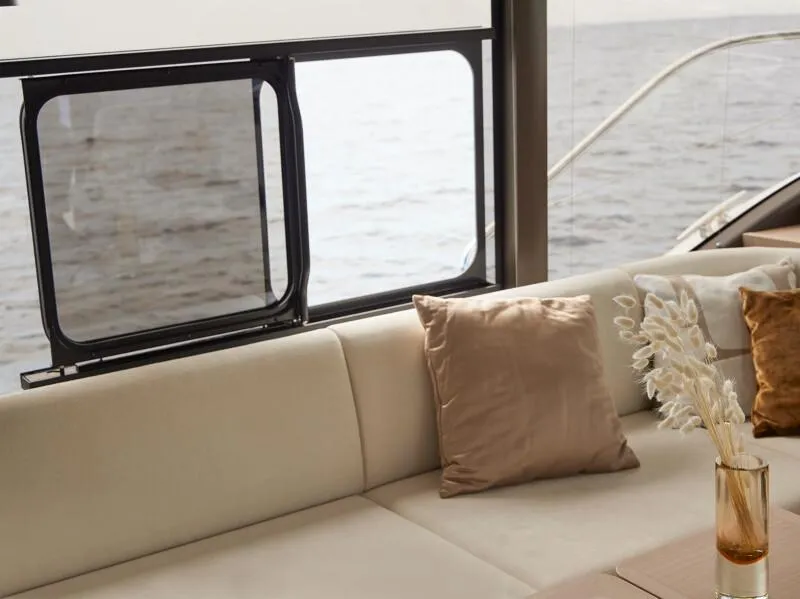 Slide: The Image of 2026 Prestige F5.7 yacht deck with sun loungers and sleek design on calm water. - 20