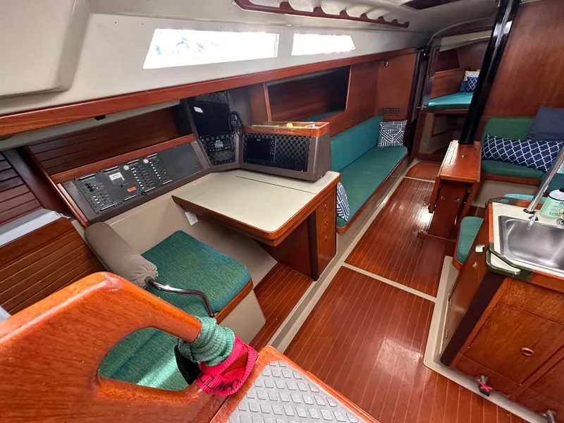Slide: The Image of Interior of 1986 C&C 41 sailboat with wood finish and green upholstery. - 16