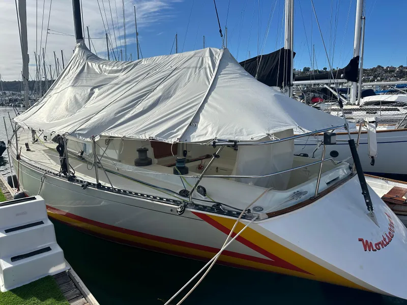Slide: The Image of 1986 C&C 41 sailboat docked with protective cover in marina. - 40