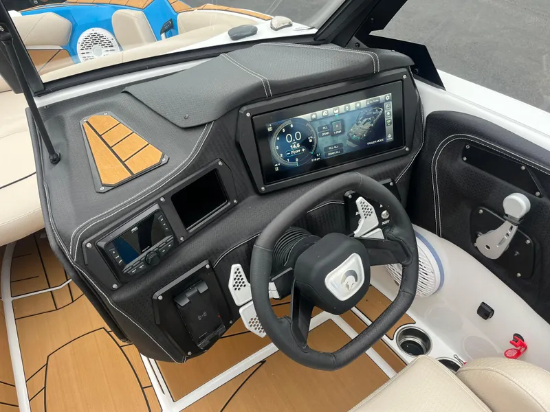 Slide: The Image of 2025 Centurion Fe22 boat dashboard with touchscreen display and steering wheel. - 7