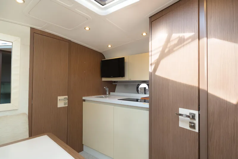 Slide: The Image of Modern interior of 2017 Beneteau Gran Turismo 40 yacht with sleek cabinetry and compact kitchen. - 10